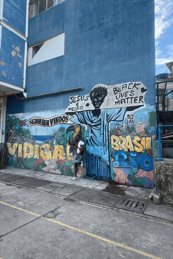 Street mural in Vidigal, Rio de Janeiro depicting a Black Christ the Redeemer figure with the words Jesus é Negro, Black Lives Matter, and Sejam Bem Vindos