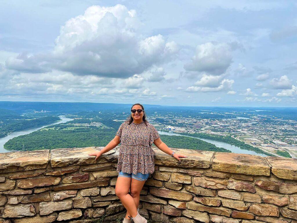 Solo traveler at the Point Park overlook wall with the Tennessee River curving around Moccasin Bend during a weekend in Chattanooga