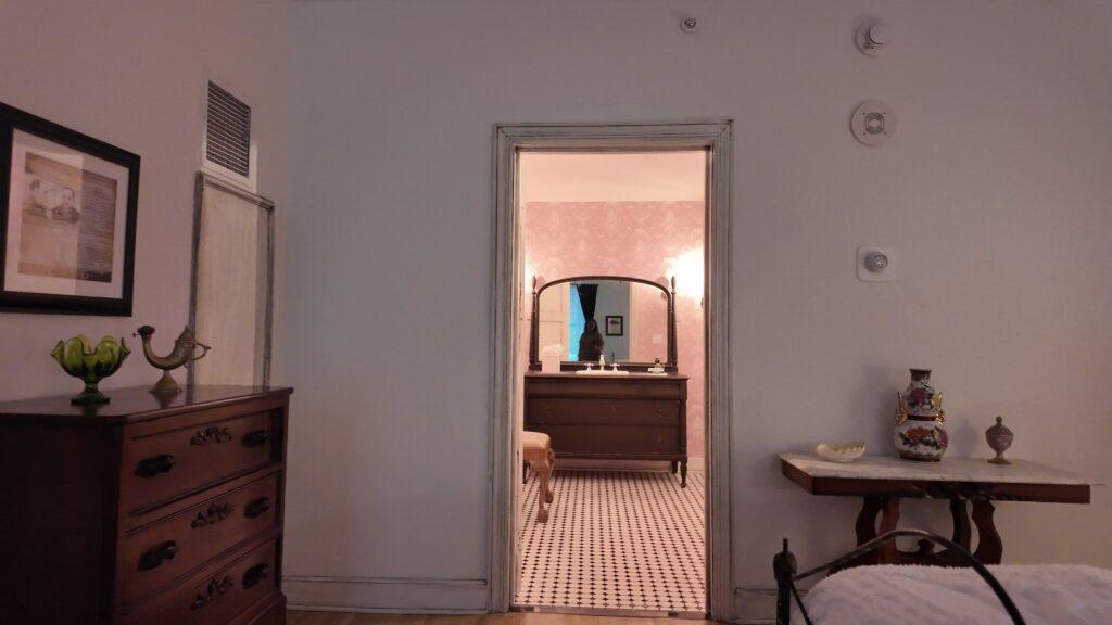 Bedroom of Room 311 looking through the doorway to the pink-tiled bathroom at the Read House, Chattanooga